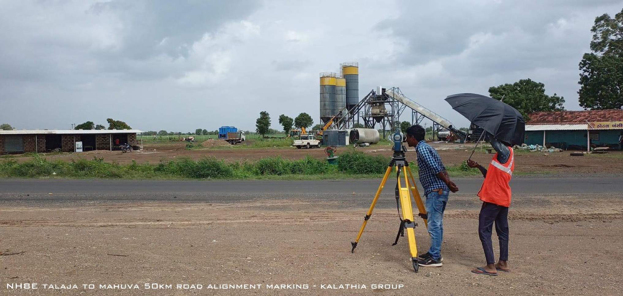 Surveyor conducting national highway survey during monsoon rain with total station