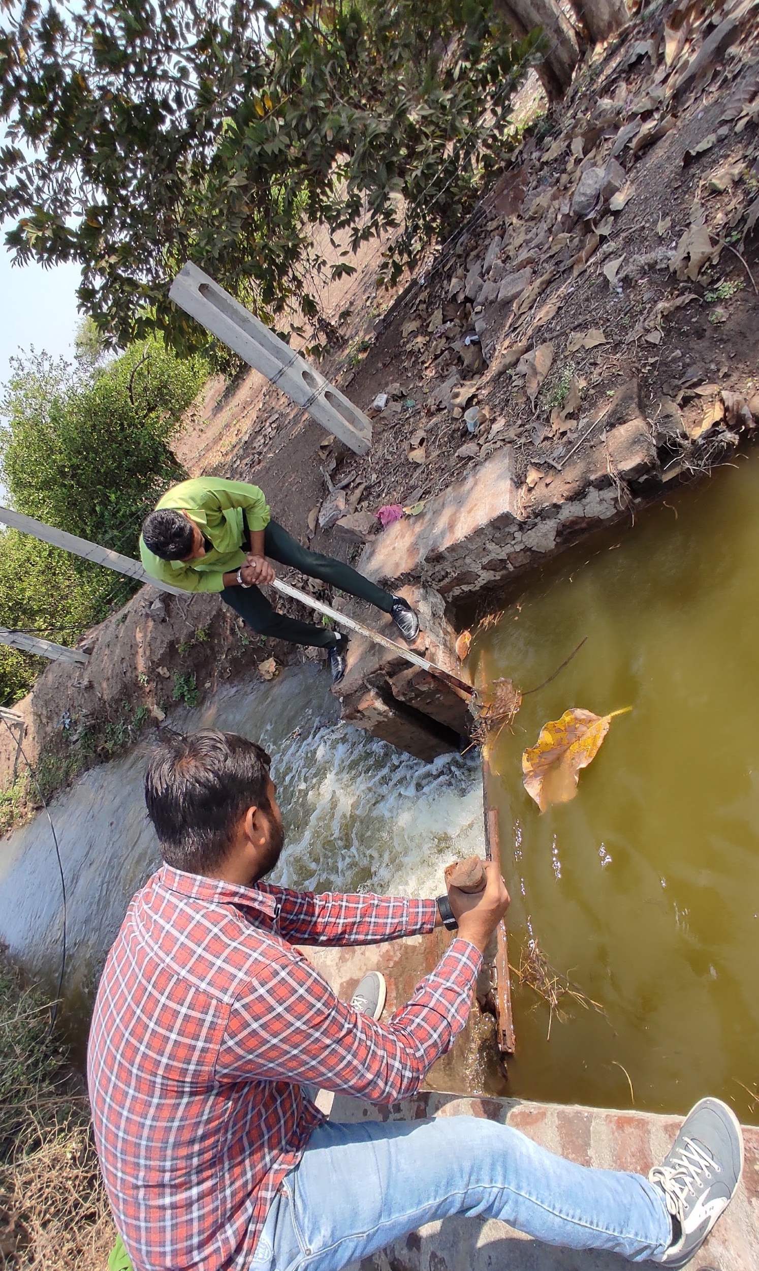 Survey team taking active canal depth reading for DGPS level survey Gujarat irrigation project